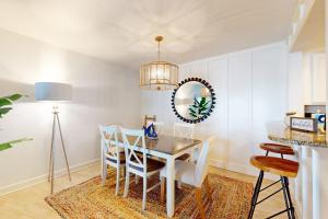 a dining room with a table and chairs and a mirror at Gulf Place 20 in Holmes Beach