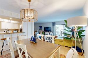 a kitchen and living room with a table and chairs at Gulf Place 20 in Holmes Beach +24 photos