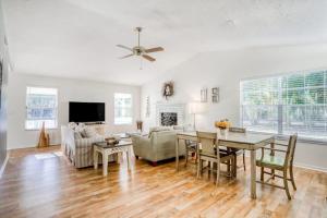 a living room with a table and a dining room at Manatee River House in Bradenton