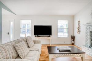 a living room with a couch and a tv at Manatee River House in Bradenton