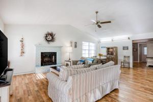 a living room with two couches and a fireplace at Manatee River House in Bradenton
