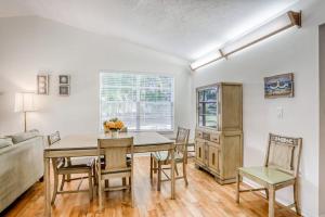 a dining room with a table and chairs and a couch at Manatee River House in Bradenton +26 photos