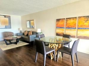 a living room with a table and chairs and a couch at Discovery Bay 3517 in Honolulu