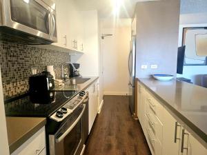 a kitchen with a sink and a stove top oven at Discovery Bay 3517 in Honolulu