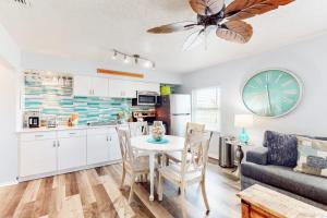 a kitchen and living room with a table and a couch at Nautical Nook at Bayview Inn in Bradenton Beach