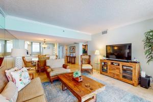 a living room with a couch and a tv at Paradise Time Hideaway in Longboat Key