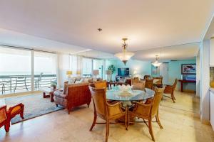 a dining room and living room with a table and chairs at Paradise Time Hideaway in Longboat Key +29 photos