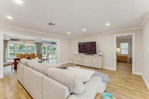a living room with a white couch and a television at Poseidons Palace in Sarasota