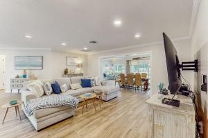 a living room with a couch and a tv at Poseidons Palace in Sarasota