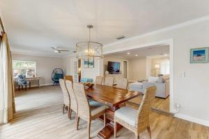 a dining room and living room with a table and chairs at Poseidons Palace in Sarasota