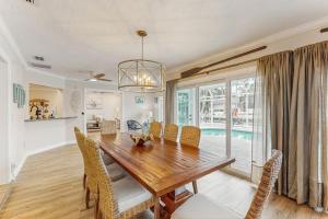 a dining room with a wooden table and chairs at Poseidons Palace in Sarasota