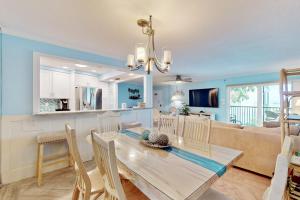 a dining room and kitchen with a table and chairs at Gulf Place 19 & 20 in Holmes Beach