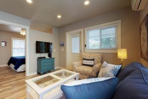 a living room with a blue couch and a tv at South Bay Inn 3 in Anna Maria +25 photos