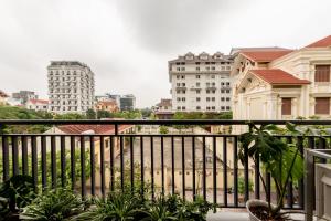 a balcony with a view of a city with buildings at La May Boutique hotel in Ninh Binh