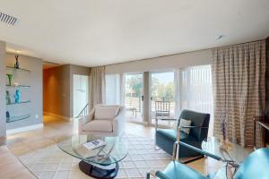 a living room with a glass table and chairs at 10 Pines - Sarasota Bay in Sarasota