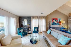 a living room with a couch and a table at 10 Pines - Sarasota Bay in Sarasota +22 photos