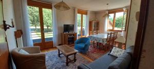 a living room with a blue couch and a table at Appartement Marthod in Marthod