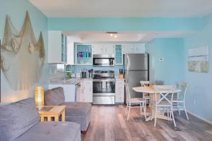 a living room with a couch and a table and a kitchen at Bungalow E in Bradenton Beach