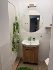 a bathroom with a sink and a mirror at Domek M5 w centrum Wiela in Wiele +20 photos