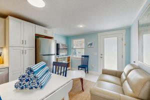 a kitchen with a couch and a table in a room at Playa Casanas South in Holmes Beach