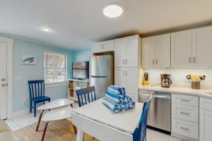 a kitchen with a table and chairs and a refrigerator at Playa Casanas North in Holmes Beach