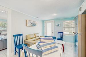 a living room with a table and chairs and a couch at Playa Casanas North in Holmes Beach