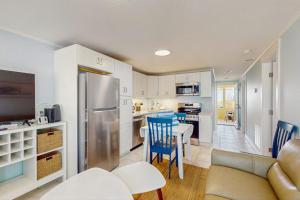 a kitchen with a refrigerator and a table and chairs at Playa Casanas North in Holmes Beach