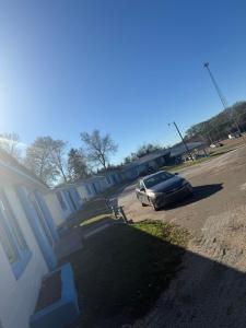 a car parked in a parking lot next to a house at Terrace Motel in Natchez