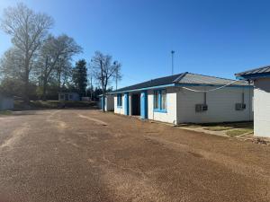 an empty parking lot in front of a building at Terrace Motel in Natchez