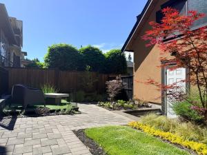 a patio with a table and a bench in a garden at Boutique in Vancouver