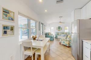 a kitchen and living room with a table and a refrigerator at Sea's The Day in Anna Maria