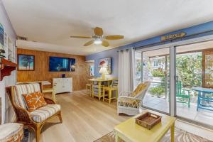 a living room with a couch and a ceiling fan at 21 Palms on Anna Maria in Anna Maria