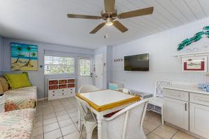 a kitchen and living room with a ceiling fan at 21 Palms on Anna Maria in Anna Maria