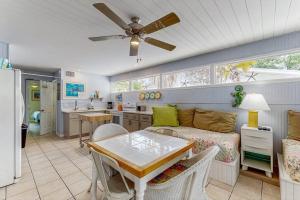 a living room with a couch and a table at 21 Palms on Anna Maria in Anna Maria
