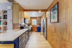 a large kitchen with wooden cabinets and a counter top at 21 Palms on Anna Maria in Anna Maria