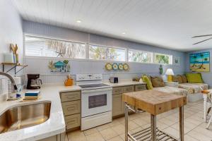 a kitchen and living room with a couch at 21 Palms on Anna Maria in Anna Maria +16 photos