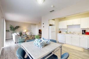 a kitchen and living room with a table and chairs at Carlton Arms View B1 # A in Bradenton