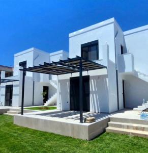 a white house with a black roof at Casa Di Elsa, Lambi, Kos in Kos