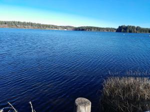 a large body of water with trees in the background at Maison rustique in Devesset