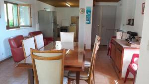 a kitchen and dining room with a table and chairs at Maison rustique in Devesset