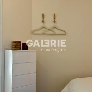 a bedroom with a dresser and a hanger on the wall at GC - Les Flots in Wissant +26 photos