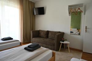 a living room with a bed and a couch at Modex ROOMS in Paraćin