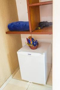 a white refrigerator with a basket on top of it at GuestHouse Casa da Aroeira in Búzios
