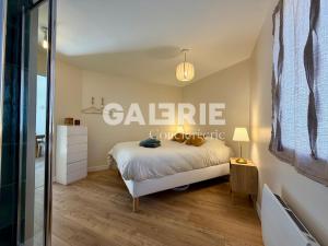 a bedroom with a bed and a sign on the wall at GC - Les Flots in Wissant