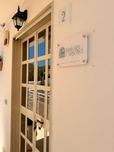 a sign on the side of a building next to a door at Dimora Caratin' in Mattinata