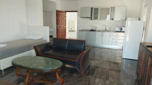a room with a bed and a chair and a table at Pogled na more in Pečurice
