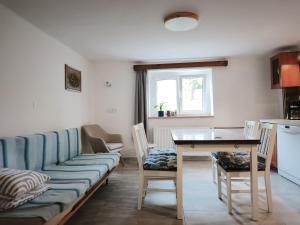 a living room with a couch and a table at Guest House Hartenberg in Sokolov