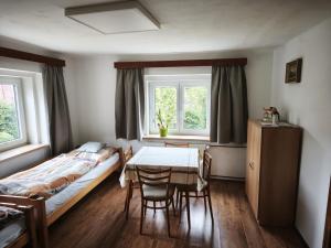 a bedroom with a bed and a table and chairs at Guest House Hartenberg in Sokolov
