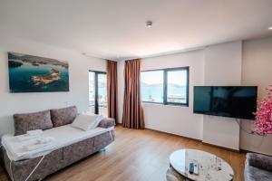 a living room with a couch and a flat screen tv at ADORA's VIEW HOTEL in Sarandë