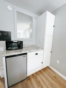a kitchen with white cabinets and a microwave at Meadow Room at The Trailblazer Unit 12 in Townsend